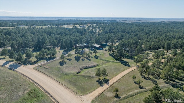 birds eye view of property with a wooded view