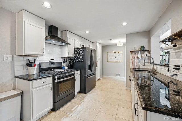 kitchen featuring range with gas cooktop, wall chimney range hood, black fridge with ice dispenser, white cabinets, and a sink