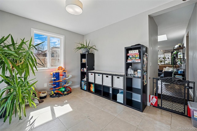 game room with tile patterned flooring and baseboards