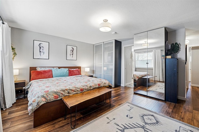 bedroom with a closet, baseboards, and hardwood / wood-style floors