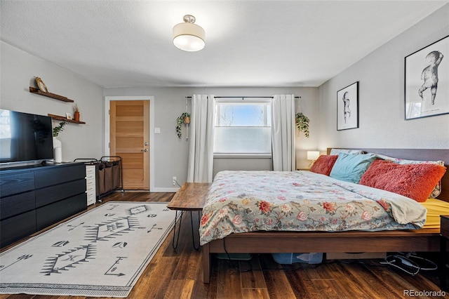 bedroom featuring baseboards and wood finished floors