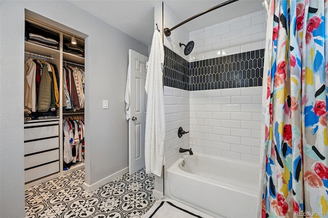 full bath featuring baseboards, a spacious closet, tile patterned flooring, and shower / bath combination with curtain