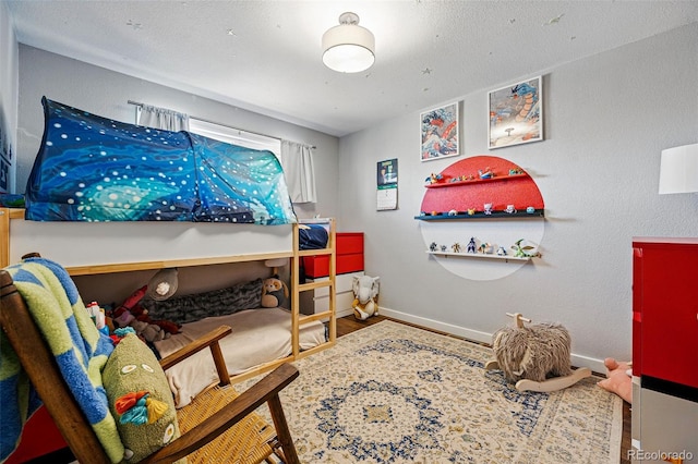 bedroom with baseboards and wood finished floors