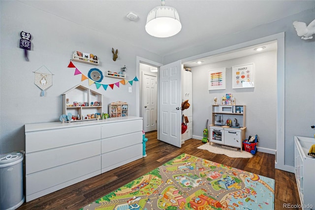 bedroom featuring dark wood-style floors and baseboards