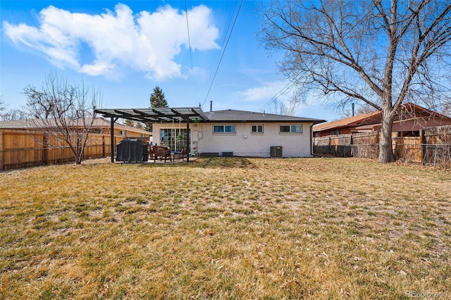 back of house with a patio, a lawn, a pergola, and a fenced backyard