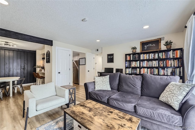 12131 Melody Dr Unit 201, Denver, CO 80234 - living room with a textured ceiling, light wood-type flooring, and recessed lighting