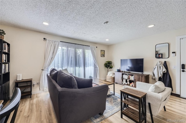 12131 Melody Dr Unit 201, Denver, CO 80234 - living area featuring a textured ceiling, light wood finished floors, and recessed lighting