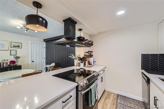 12131 Melody Dr Unit 201, Denver, CO 80234 - kitchen with appliances with stainless steel finishes, island exhaust hood, white cabinets, light wood-style flooring, and decorative light fixtures