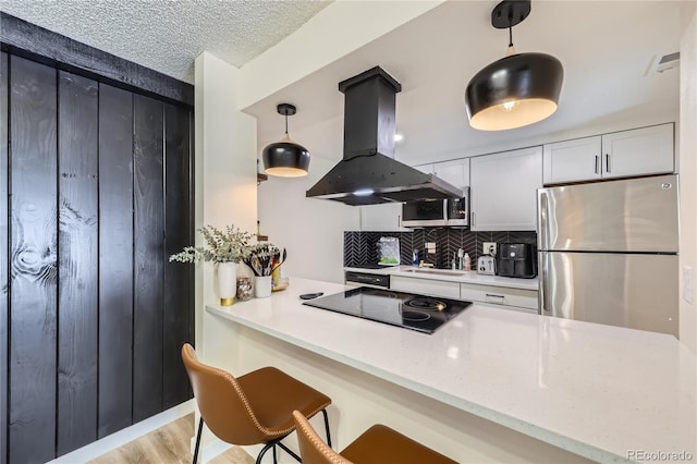 12131 Melody Dr Unit 201, Denver, CO 80234 - kitchen featuring stainless steel appliances, island range hood, backsplash, decorative light fixtures, and a kitchen breakfast bar