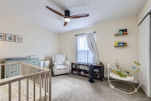 12131 Melody Dr Unit 201, Denver, CO 80234 - carpeted bedroom featuring a textured ceiling, a nursery area, a closet, and ceiling fan