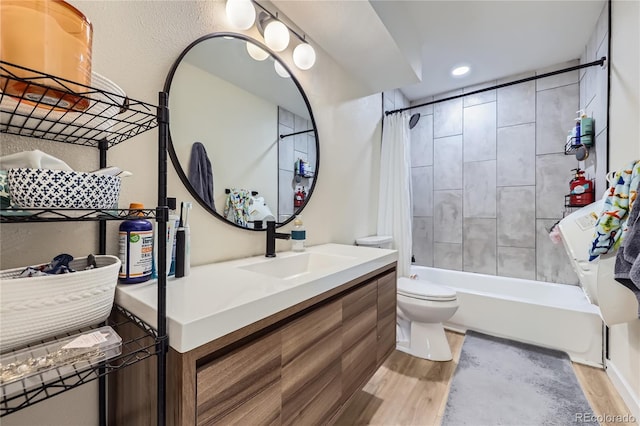 12131 Melody Dr Unit 201, Denver, CO 80234 - bathroom featuring vanity, shower / bath combo with shower curtain, wood finished floors, and recessed lighting