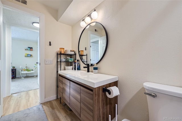 12131 Melody Dr Unit 201, Denver, CO 80234 - bathroom featuring wood finished floors and vanity