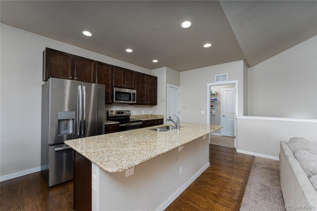 8110 Somersby Pl, Colorado Springs, CO 80908 - kitchen featuring appliances with stainless steel finishes, a sink, baseboards, a kitchen island with sink, and dark brown cabinets