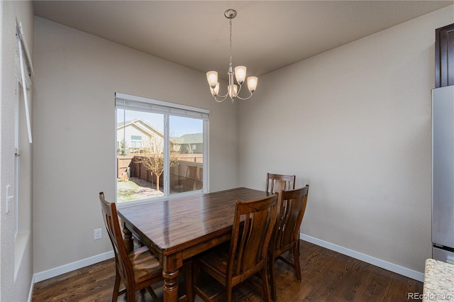 8110 Somersby Pl, Colorado Springs, CO 80908 - dining room featuring a chandelier, dark wood finished floors, and baseboards