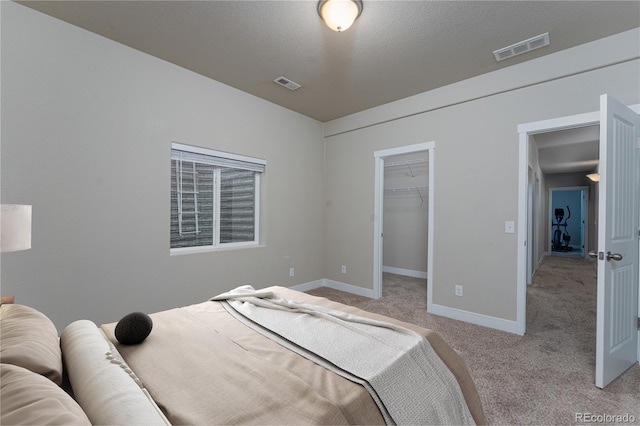 8110 Somersby Pl, Colorado Springs, CO 80908 - bedroom featuring light carpet, baseboards, a walk in closet, and a closet