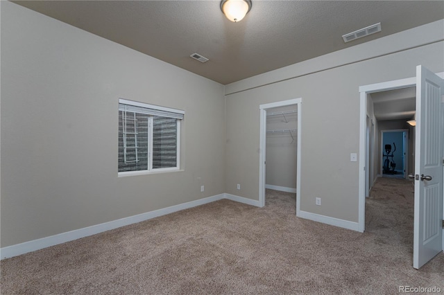 8110 Somersby Pl, Colorado Springs, CO 80908 - unfurnished bedroom featuring carpet floors, baseboards, a spacious closet, a closet, and a textured ceiling