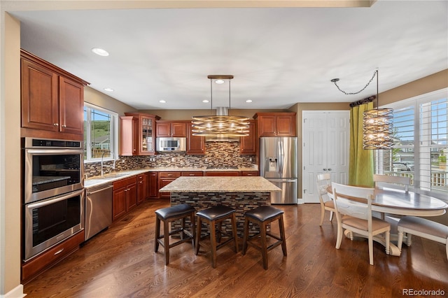 1133 Lucky Ct, Castle Rock, CO 80109 - kitchen featuring stainless steel appliances, plenty of natural light, a sink, a kitchen bar, and recessed lighting