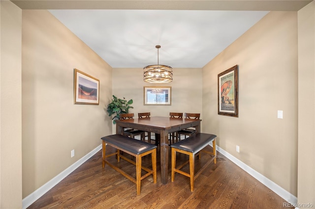 1133 Lucky Ct, Castle Rock, CO 80109 - dining room featuring baseboards, dark wood-type flooring, and a chandelier