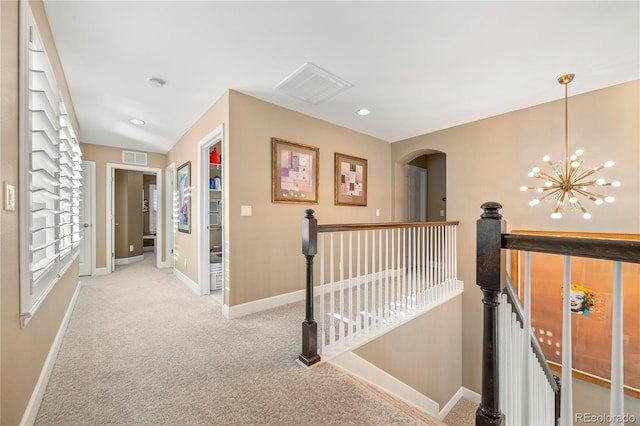 1133 Lucky Ct, Castle Rock, CO 80109 - corridor featuring an upstairs landing, light colored carpet, a chandelier, baseboards, and arched walkways