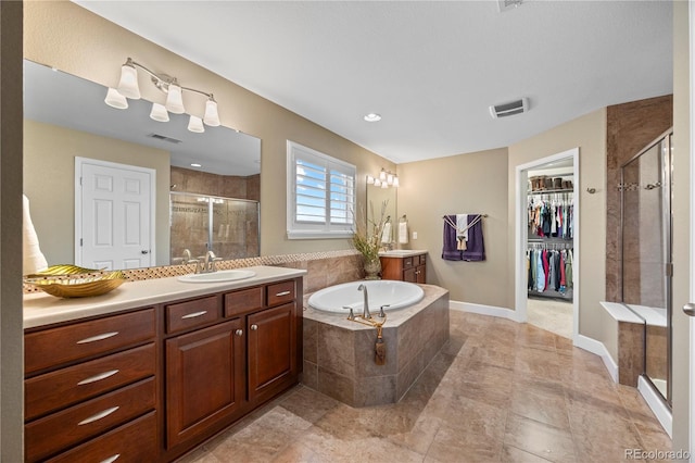 1133 Lucky Ct, Castle Rock, CO 80109 - bathroom with vanity, a shower stall, a bath, and a walk in closet