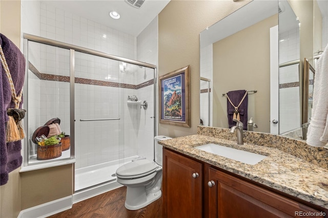 1133 Lucky Ct, Castle Rock, CO 80109 - full bath with toilet, wood finished floors, vanity, and a shower stall