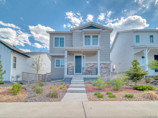 8018 Williams Fork Ave, Littleton, CO 80125 - craftsman-style home with covered porch, fence, and stone siding