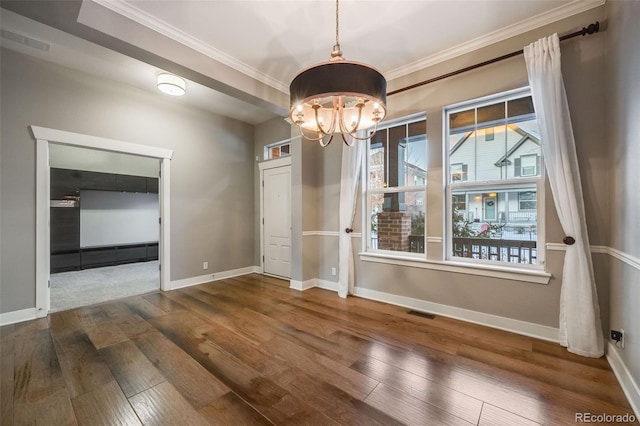 unfurnished dining area with an inviting chandelier, a baseboard radiator, ornamental molding, and dark hardwood / wood-style floors