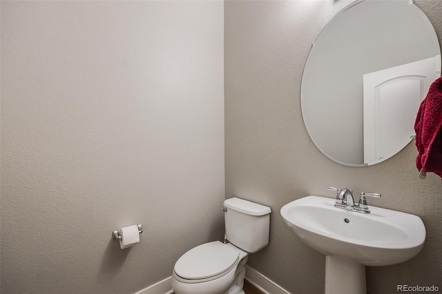 bathroom featuring toilet and sink