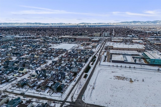 snowy aerial view with a mountain view