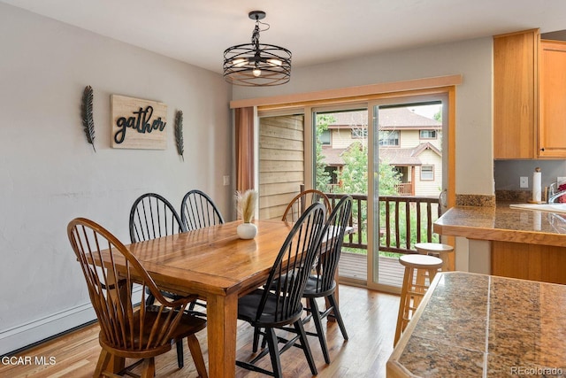 129 Logger Ln, Winter Park, CO 80482 - dining space with light wood-style floors and a chandelier