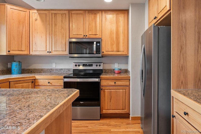 129 Logger Ln, Winter Park, CO 80482 - kitchen featuring stainless steel appliances, light wood-type flooring, tile countertops, and light brown cabinetry