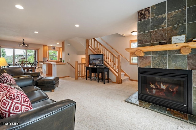 129 Logger Ln, Winter Park, CO 80482 - living area with carpet floors, recessed lighting, a tile fireplace, and stairs