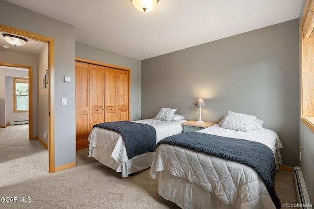 129 Logger Ln, Winter Park, CO 80482 - bedroom featuring light carpet, baseboard heating, and a closet