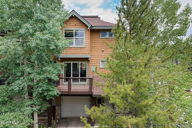 129 Logger Ln, Winter Park, CO 80482 - view of front of house featuring an attached garage, a balcony, and driveway