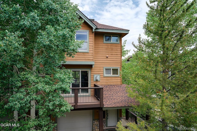 129 Logger Ln, Winter Park, CO 80482 - back of house featuring a shingled roof and an attached garage
