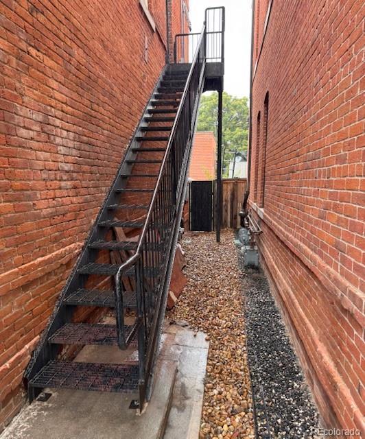 2801 Champa St, Denver, CO 80205 - view of property exterior with stairs and brick siding