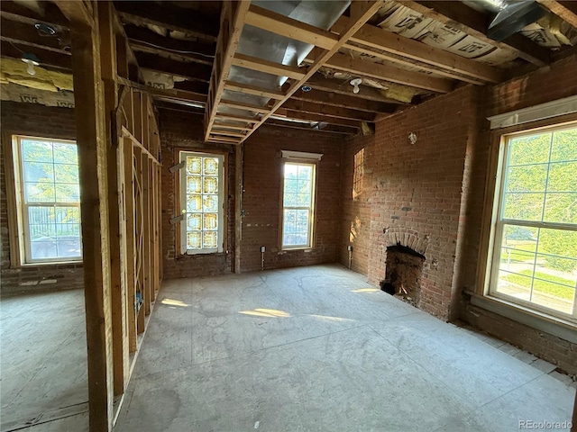 2801 Champa St, Denver, CO 80205 - unfurnished living room with a brick fireplace and brick wall