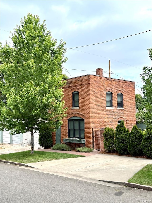2801 Champa St, Denver, CO 80205 - view of front facade with brick siding and a chimney