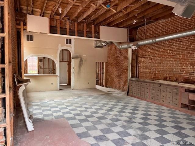 2801 Champa St, Denver, CO 80205 - misc room featuring tile patterned floors and brick wall
