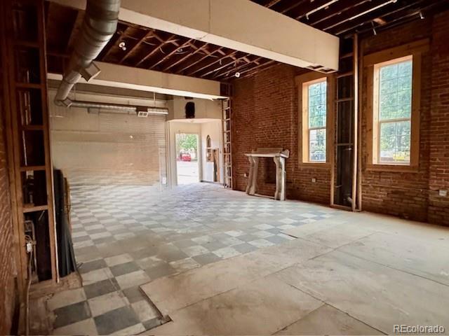 2801 Champa St, Denver, CO 80205 - misc room with tile patterned floors and brick wall