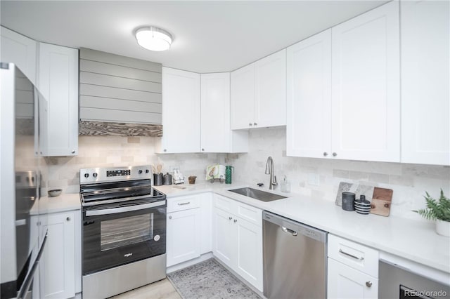 9155 E Center Ave Unit 4B, Denver, CO 80247 - kitchen featuring stainless steel appliances, a sink, backsplash, and white cabinetry