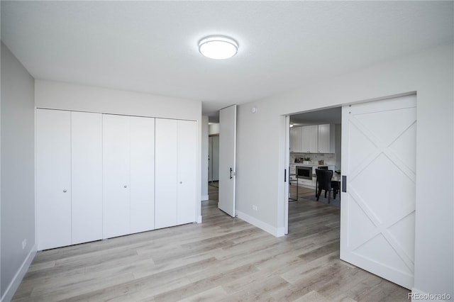 unfurnished bedroom with light wood-type flooring