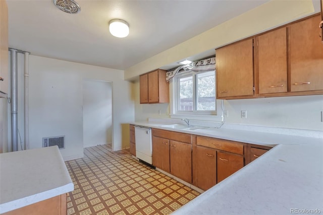 kitchen featuring white dishwasher and sink