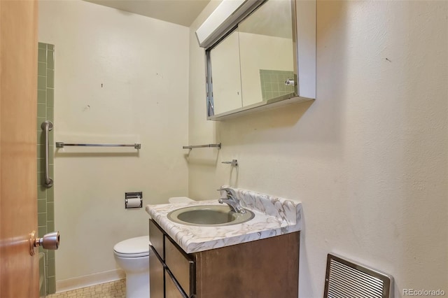 bathroom featuring tile patterned flooring, vanity, and toilet