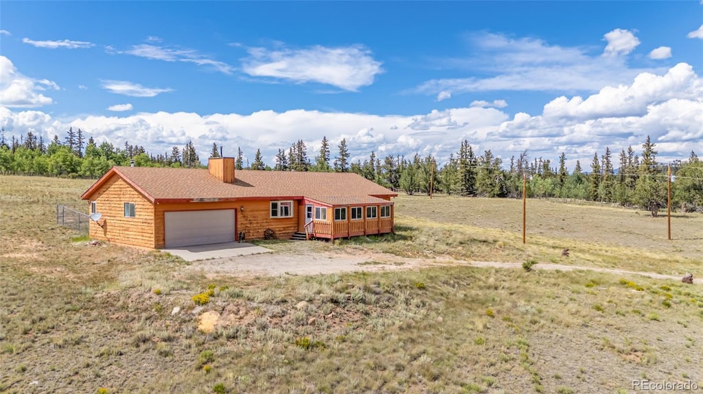 view of front of house with a garage and a wooden deck