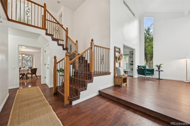 8424 E Otero Cir, Centennial, CO 80112 - stairs featuring high vaulted ceiling, wood finished floors, and baseboards