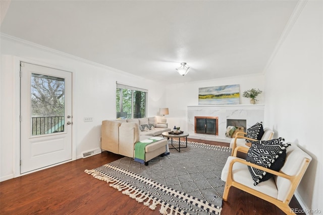 8424 E Otero Cir, Centennial, CO 80112 - living room with crown molding, wood finished floors, a fireplace, and baseboards