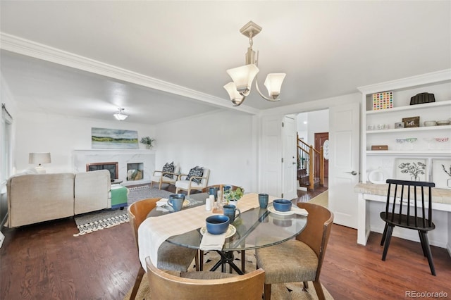 8424 E Otero Cir, Centennial, CO 80112 - dining space with wood finished floors, a chandelier, crown molding, a high end fireplace, and stairs