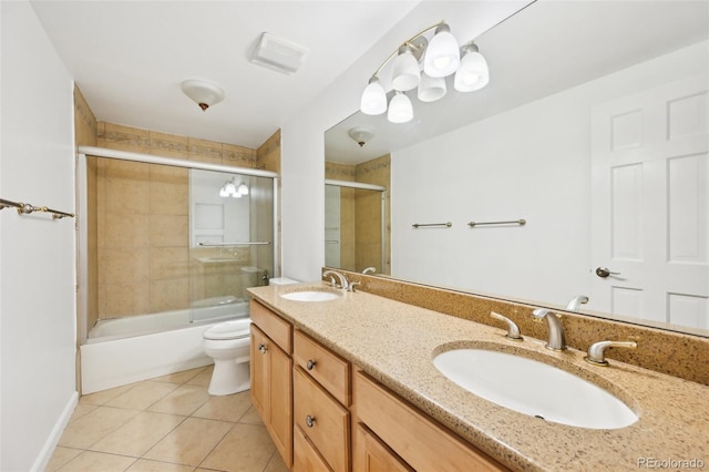 8424 E Otero Cir, Centennial, CO 80112 - full bath with tile patterned floors, toilet, double vanity, and enclosed tub / shower combo