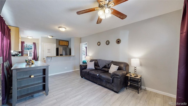 living room with light wood-type flooring and ceiling fan